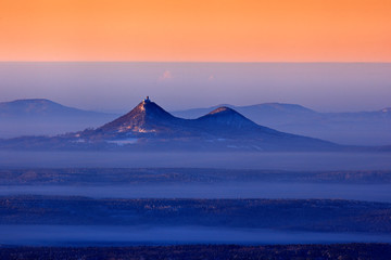 Czech landscape aerial view, Bezdez hill. Pink morning light before sunrise. Winter twilight, cold...
