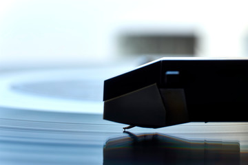 Extreme closeup of turntable record player with stylus in focus. Retro hipster analog musical...