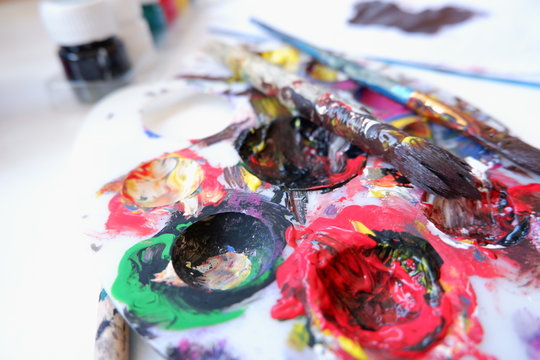 Baby paints and brushes on small table messy 