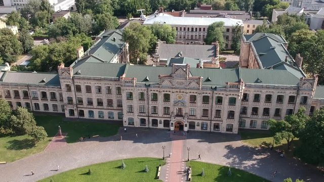 Aerial view Polytechnic Institute in Kiev in the summer. People walk near the institute At the top of the building, the flag of Ukraine is developing