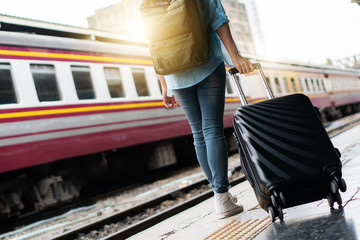 Solo woman backpacker traveler plan safety trip low cost budget summer holiday after coronavirus. Empty tourist on train railway platform. Use bus train sustainable environmental friendly transport