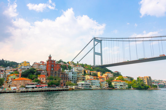 istanbul, turkey - AUG 18, 2015: fatih sultan mehmet bridge above the bosphorus. beautiful cityscape of historical area observed from the water on a sunny summer day. calm weather with fluffy clouds
