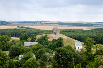 Fototapeta na wymiar Scenic view on Pidkamin inselberg on adjacent hill in Brody region of Galychyna