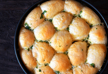 homemade buns with garlic and parsley in a pan