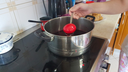 red easter eggs  while painting and polishing in the kitchen