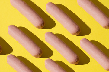 Many sausages pattern on bright yellow background
