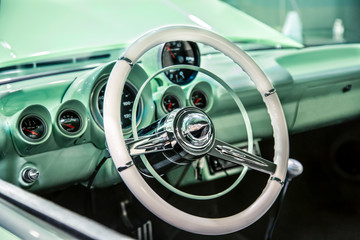  Interior View of Restored 50s Vintage Automobile Dashboard Steering Wheel, Out of Focus Open Hood
