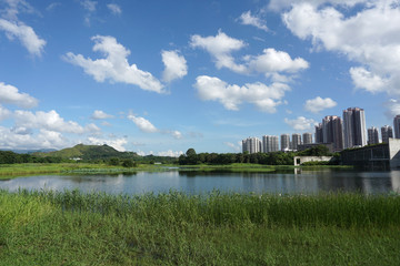Scenic view of lake and building against sky, Hong Kong Wetland Park