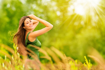 Naklejka na ściany i meble Outdoor Portrait of Happy Young Woman in Nature. Attractive Girl in Sunny Summer Green Park