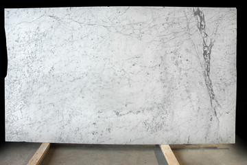 A large slab of natural white marble with gray veins is called Bianco Gioia