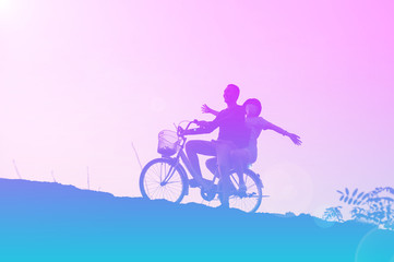 Fototapeta na wymiar silhouette of couple driving bike happy time sunset