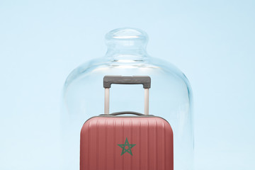 Luggage in isolation under glass cover covid-19 Morocco tourism abstract.