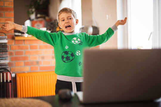 The Boy Practices At Home In Front Of The Computer As Part Of An Online Physical Education Lesson Due To Closed Schools Becouse Of Pandemic Coronavirus Covid-19