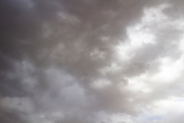 Clouds in the blue sky. A stunning gray sky. The storm is approaching. A beautiful clouds against the blue sky background. Amazing cloud pattern in the sky.
