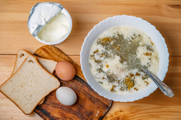 Delicious green soup with sorrel on wooden table