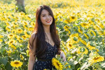 Asian cute young woman joyful, smiling with sunflowers background.