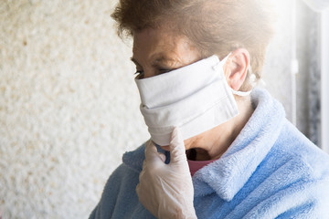 portrait of senior woman with disposable medical mask. Safety in public places during coronavirus outbreak.