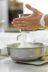 Cooking Baking. Cook sifts the flour a