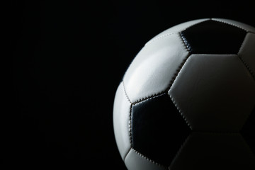 Fototapeta premium classic soccer ball with shadow on black background with copy space