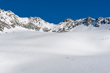Fototapeta na wymiar Panoramic view across snow covered valley in alpine mountain range