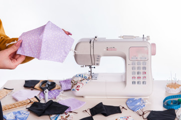The girl holds a exclusive medical mask in her hands. Hands close up 