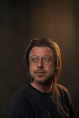 Studio portrait of a man wearing retro glasses.