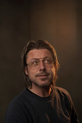 Studio portrait of a man wearing retro glasses.