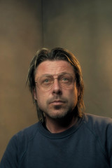 Studio portrait of a man wearing retro eyewear.