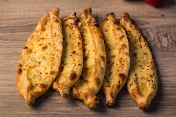 traditional cheese pita with vegetables on wooden background