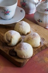 .chocolate filled cookies on colored background with teapot and cup