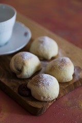 .chocolate filled cookies on colored background with teapot and cup