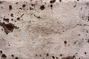 Texture of a concrete wall with cracks and scratches which can be used as a background