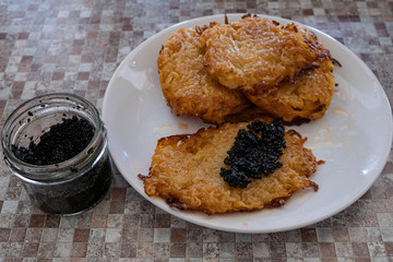 potato pancakes with black caviar