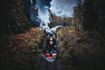 Old soviet steam locomotive passing though Karelian forrest