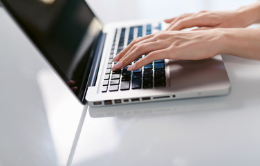 Young business woman is typing on laptop keyboard. Coronavirus. Quarantine. isolation, social distancing, freelance work from home office, self-isolation.