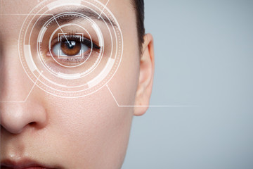 The young woman 's eye is close-up. The concept of the new technology is iris recognition.