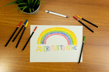 Set with plant pen pencils and Paper with rainbows and a phrase in italian saying Everything will be alright