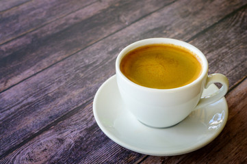 Hot coffee americano on the old wooden table