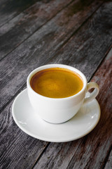 Hot coffee americano on the old wooden table