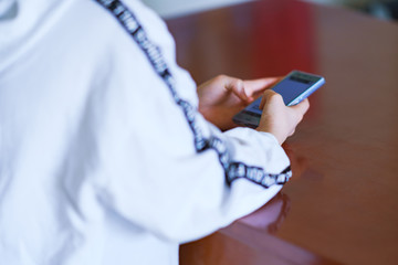 Fototapeta premium Japanese girl looking smart phone at home