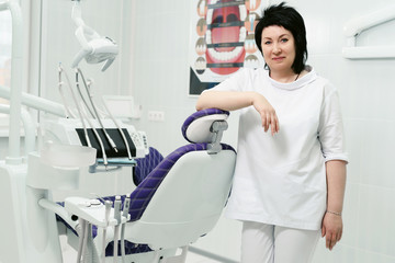 Senior woman dentist smiling at her office