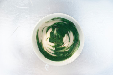 Spirulina yogurt on metallic background
