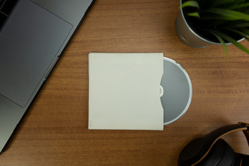 Empty CD and CD case in a wood background with objects for mockup purposes