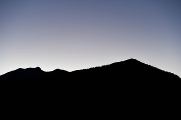 Silhouette of a mountain lit by the setting sun in the Tusheti region.