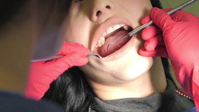 Female dentist doing dental treatment to her patient in clinic