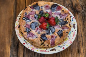 chocolate and strawberry cake on the wooden background