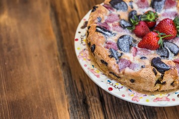 chocolate and strawberry cake on the wooden background