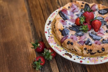 chocolate and strawberry cake on the wooden background