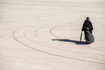 plague doctor alone on a large paved area