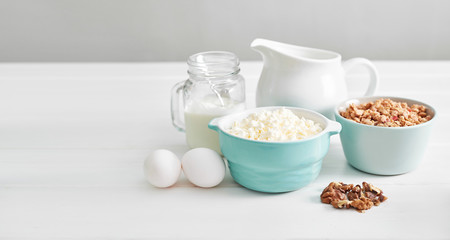 Clean eating healthy cooking ingredients. Food frame. Superfoods concept. Fitness Breakfast.Healthy eating and food, dieting, vegetarian kitchen, Cottage cheese and oatmeal with milk on table